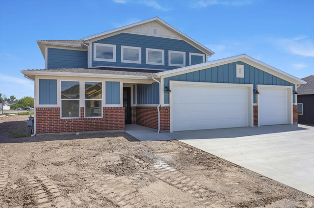 1315 West 3200 South, Unit 17 Perry, UT 84302 - Photo 3 of 58 Two-story property featuring blue siding and brick veneer