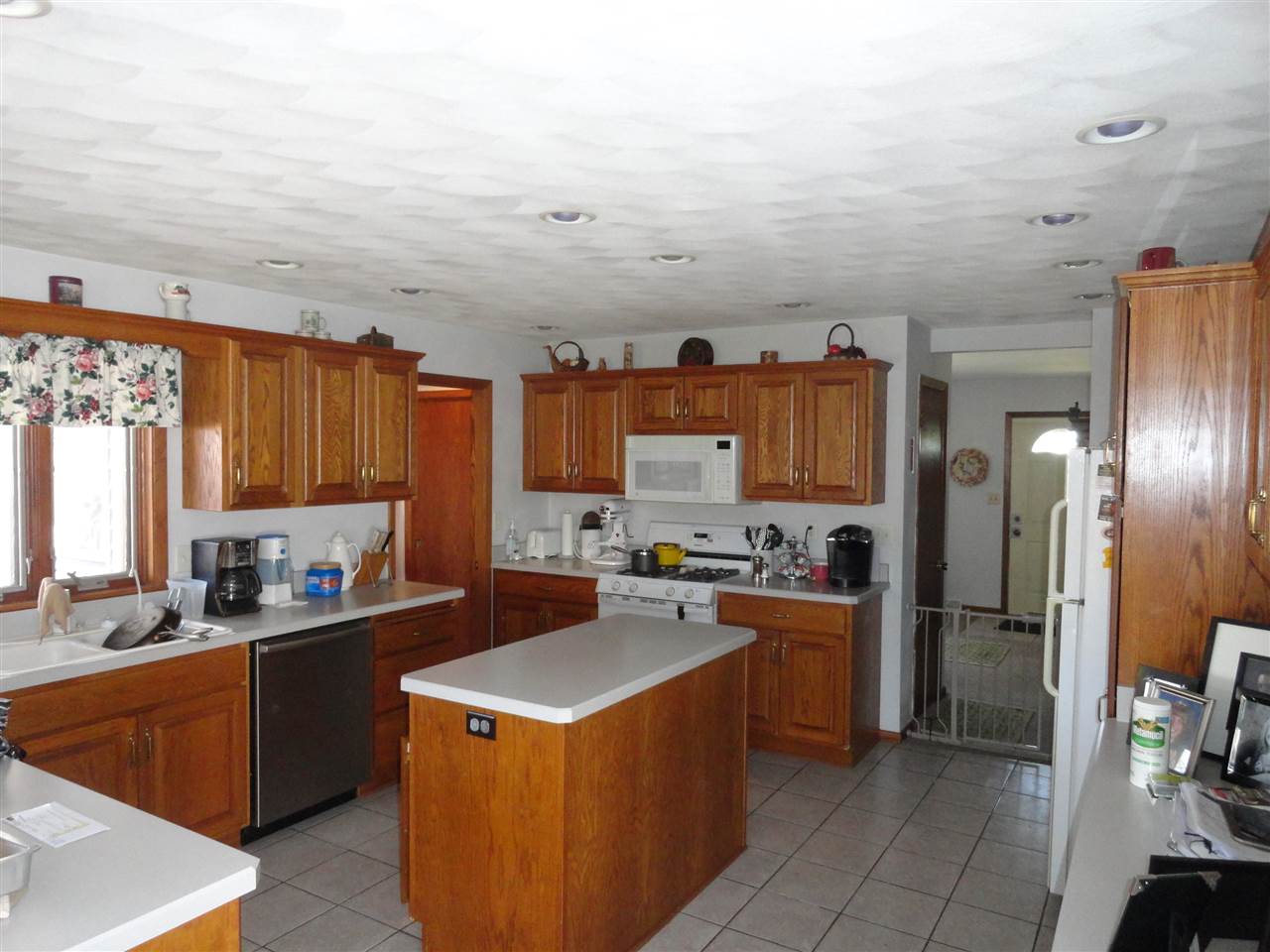 5375 Baxter Road Rockford, IL 61109 - Photo 5 of 14 a kitchen with a sink a stove and refrigerator