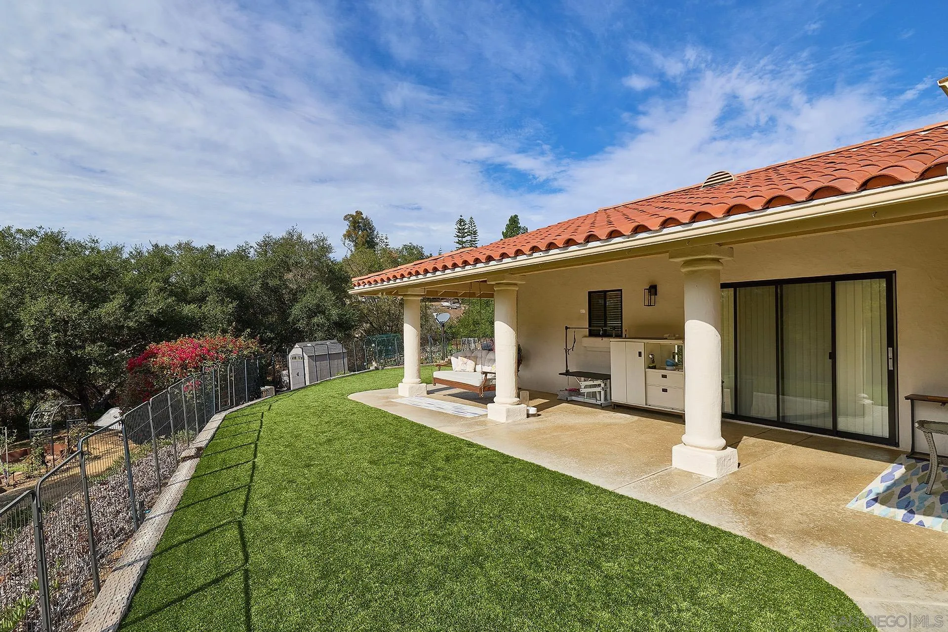 3064 Live Oak Park Road Fallbrook, CA 92028 - Photo 49 of 74 a view of a patio with table and chairs a barbeque and wooden fence