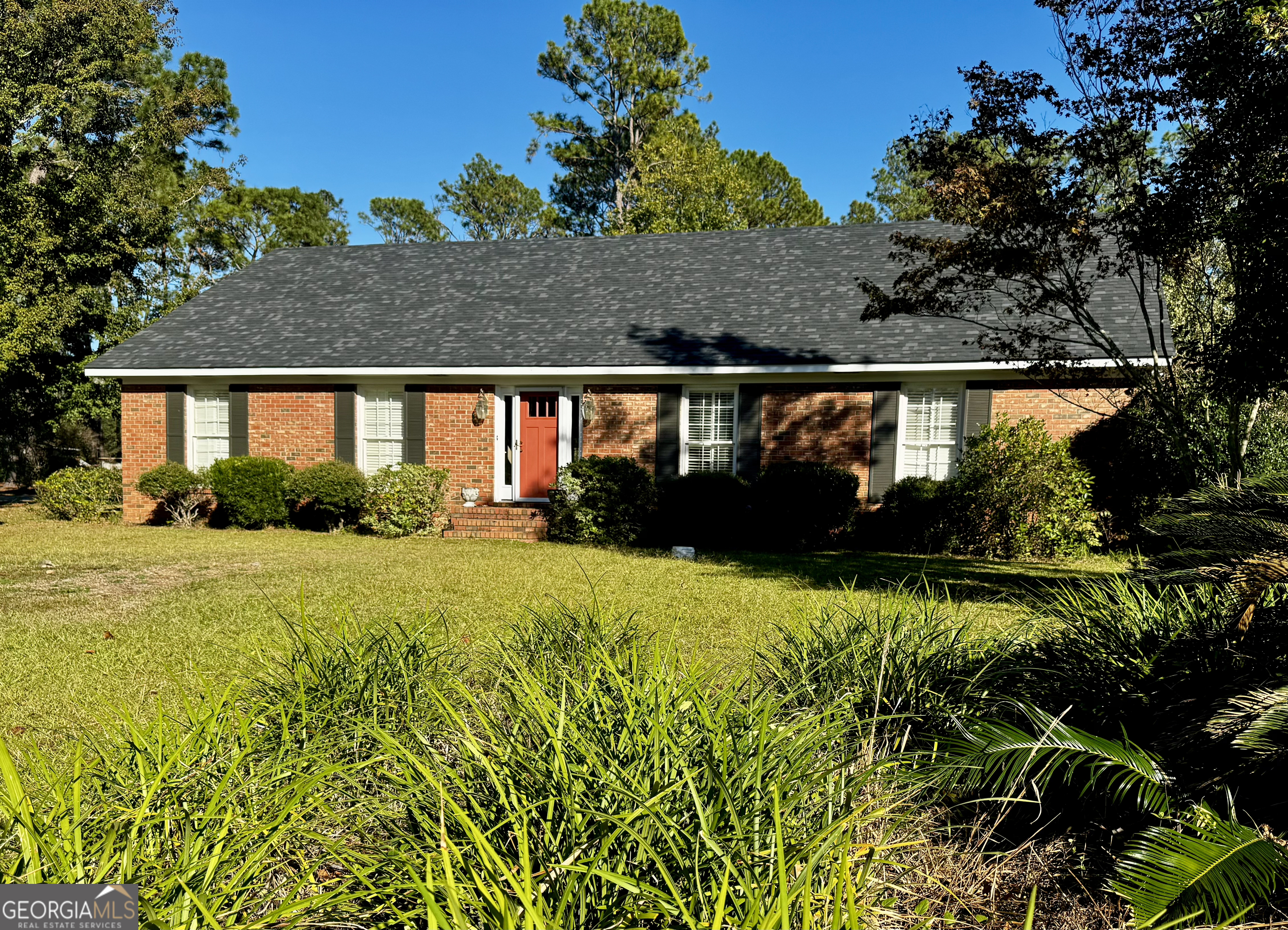 a view of house next to a yard with green space