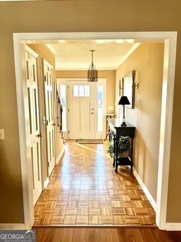 a hallway with wooden floor and furniture