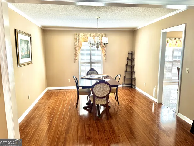 a view of a dining room with furniture window and wooden floor