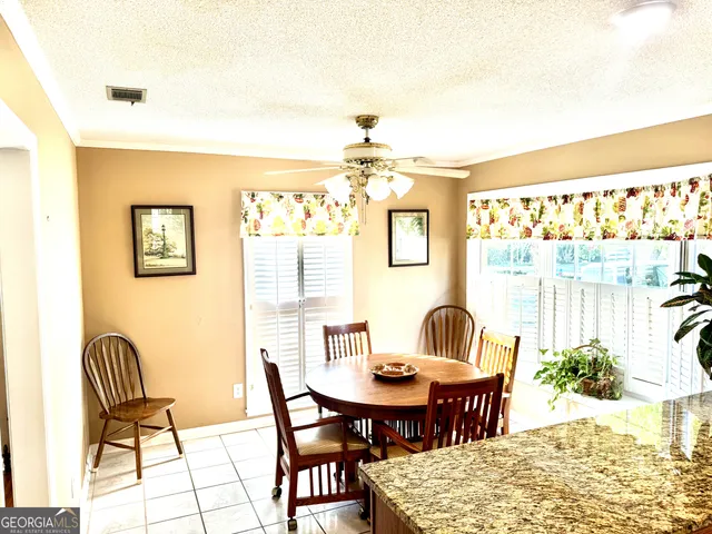 a view of a dining room with furniture and window