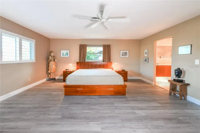 a bedroom with a bed and wooden floor