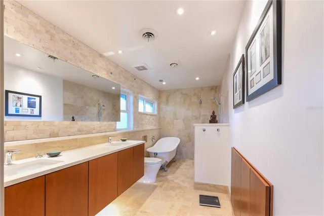 a large bathroom with a sink a large mirror and a bathtub
