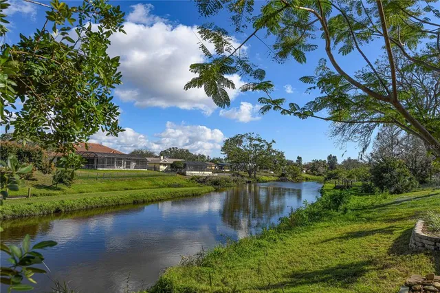 an aerial view of a house with a yard and lake view