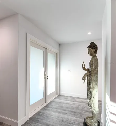 a view of a room with wooden floor and a hallway