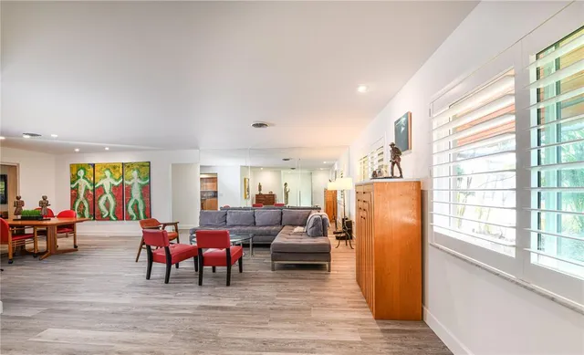 a living room with furniture window and wooden floor