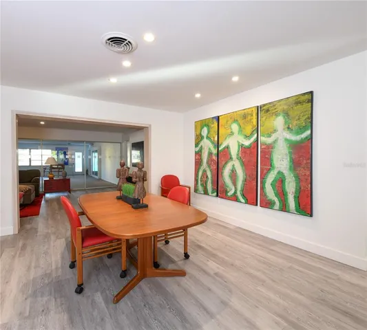 a view of a dining room with furniture and wooden floor