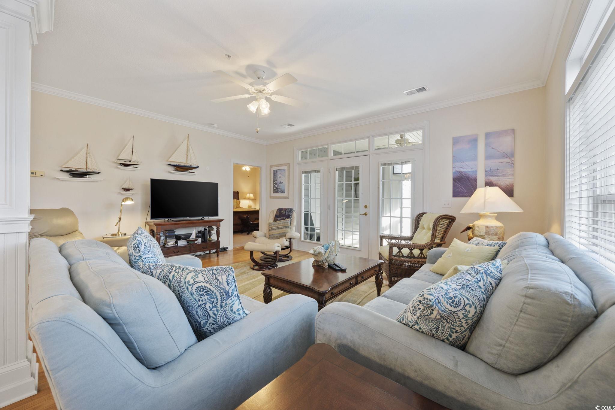 219 Moonglow Circle, Unit 102 Murrells Inlet, SC 29576 - Photo 5 of 34 Living room with a wealth of natural light, crown