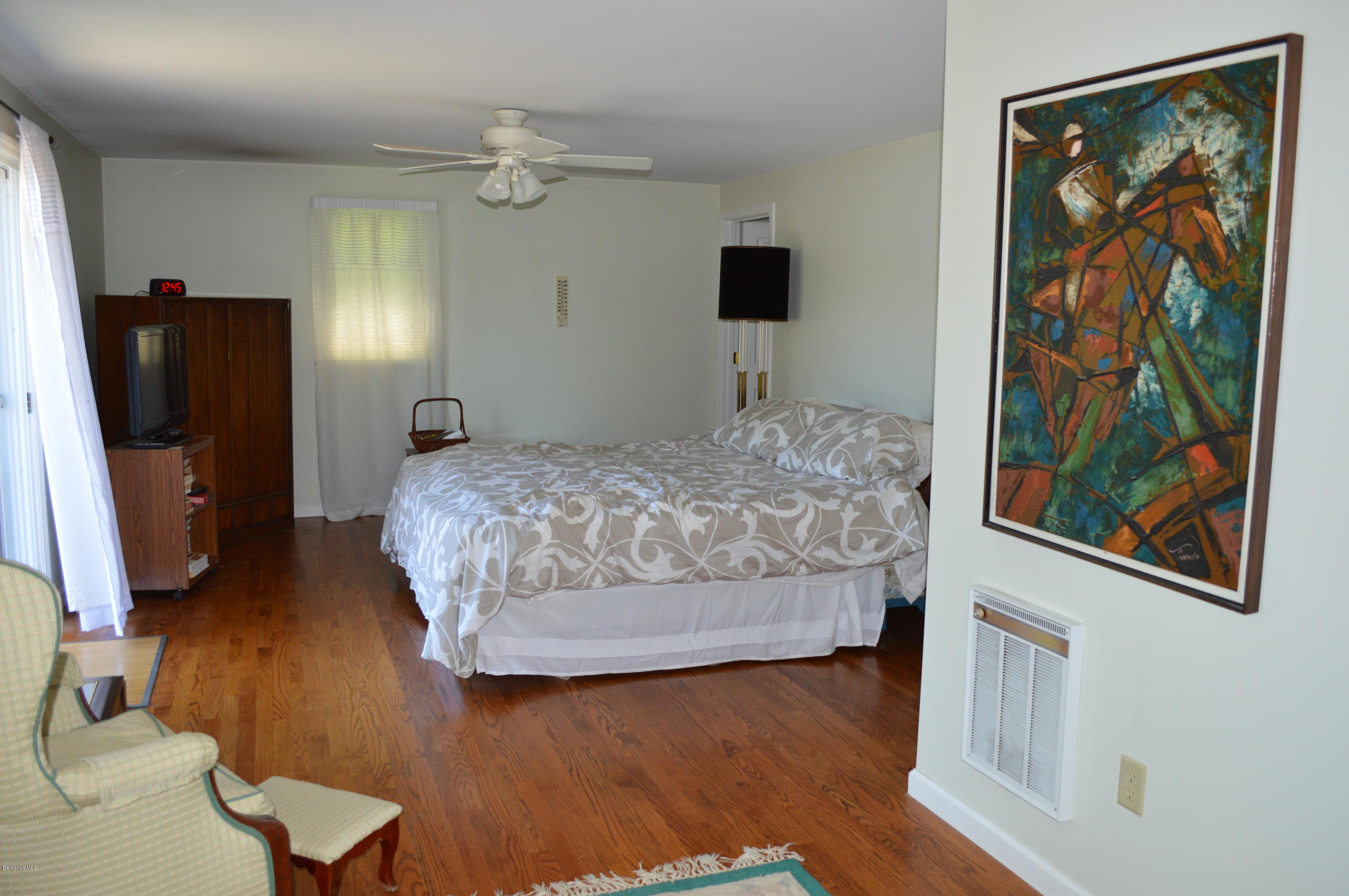 1381 East Otis Road Otis, MA 01029 - Photo 22 of 48 a bedroom with a bed and a painting on the wall
