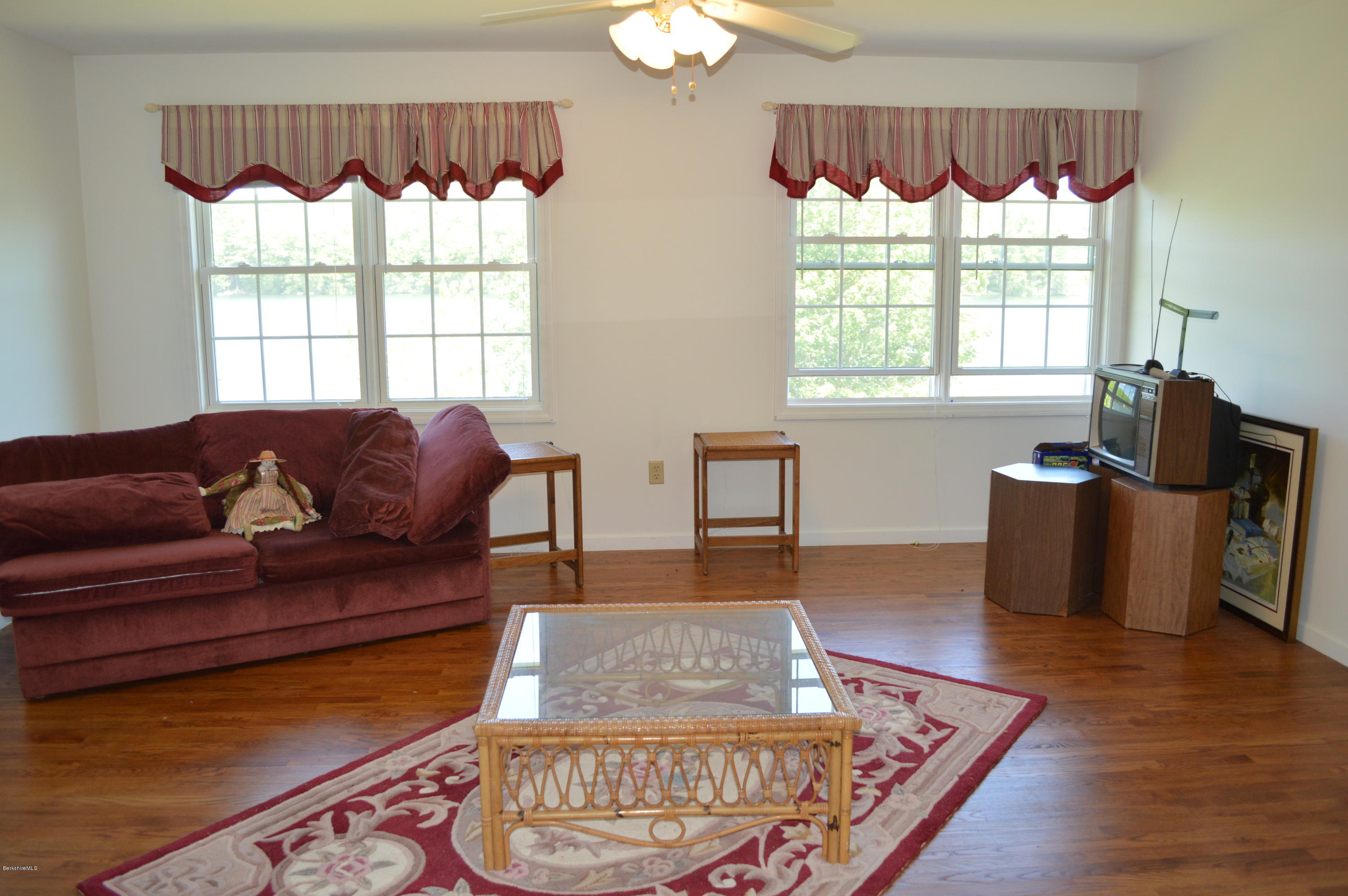1381 East Otis Road Otis, MA 01029 - Photo 30 of 48 a living room with furniture and a floor to ceiling window