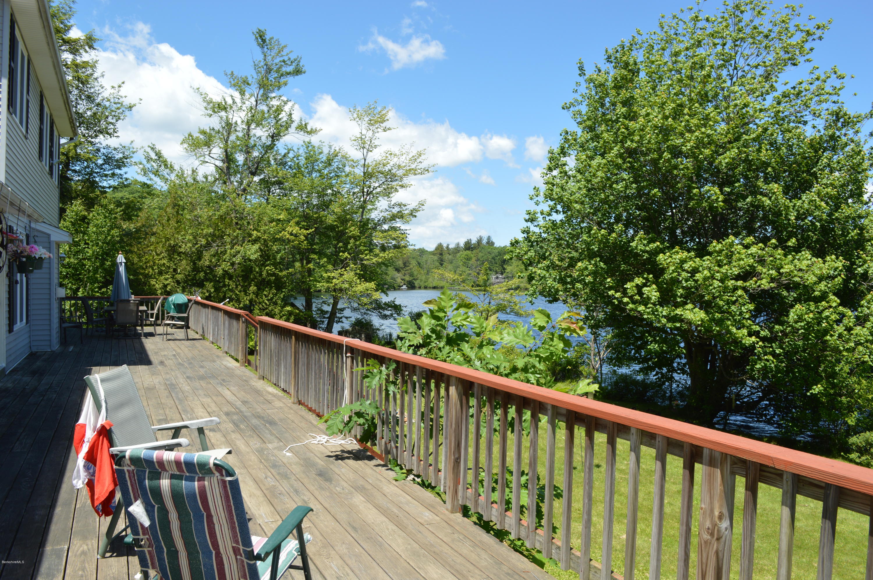 1381 East Otis Road Otis, MA 01029 - Photo 33 of 48 a balcony with wooden floor and trees in the back