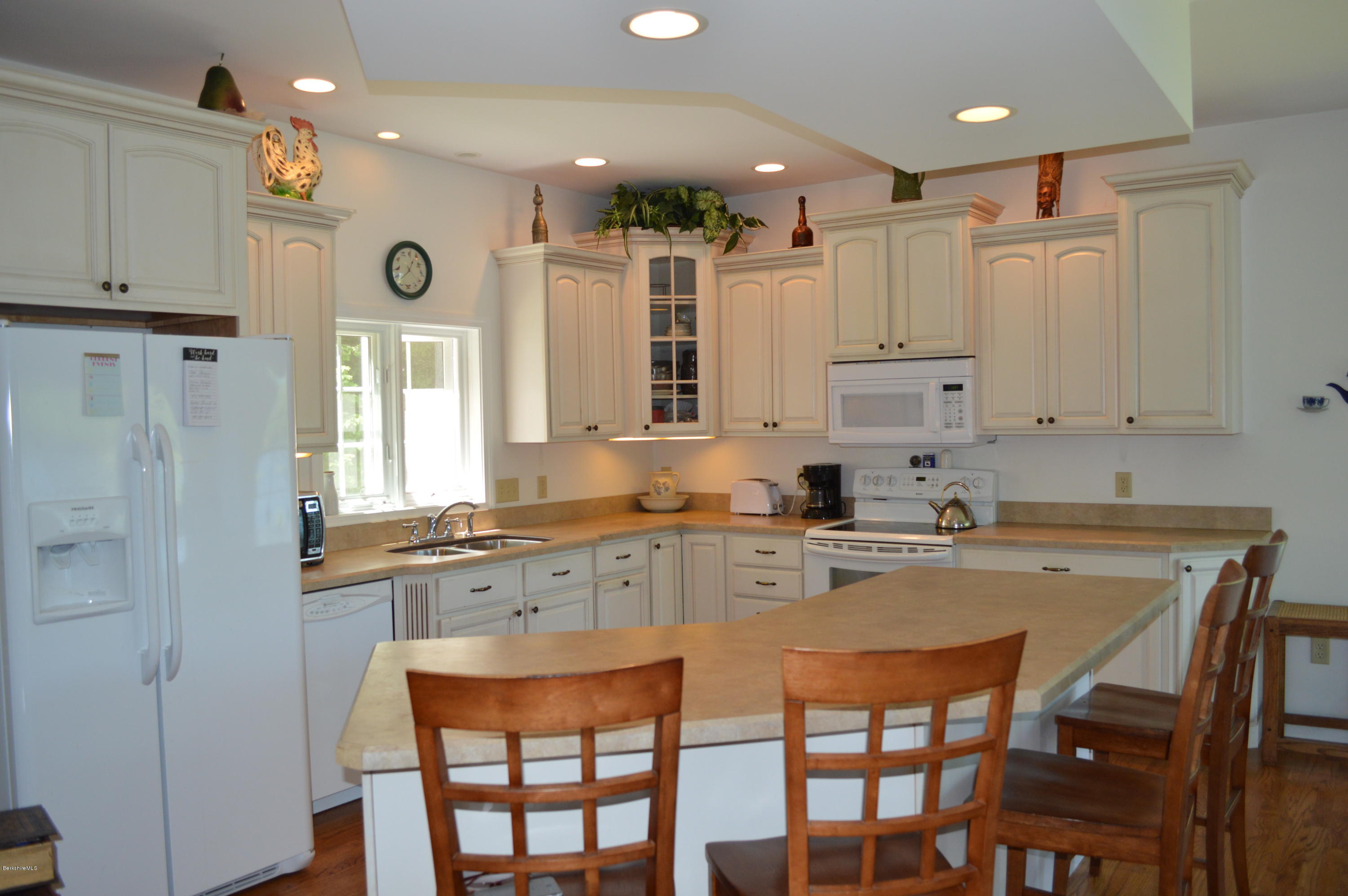 1381 East Otis Road Otis, MA 01029 - Photo 5 of 48 a kitchen with stainless steel appliances granite countertop a table chairs sink and cabinets