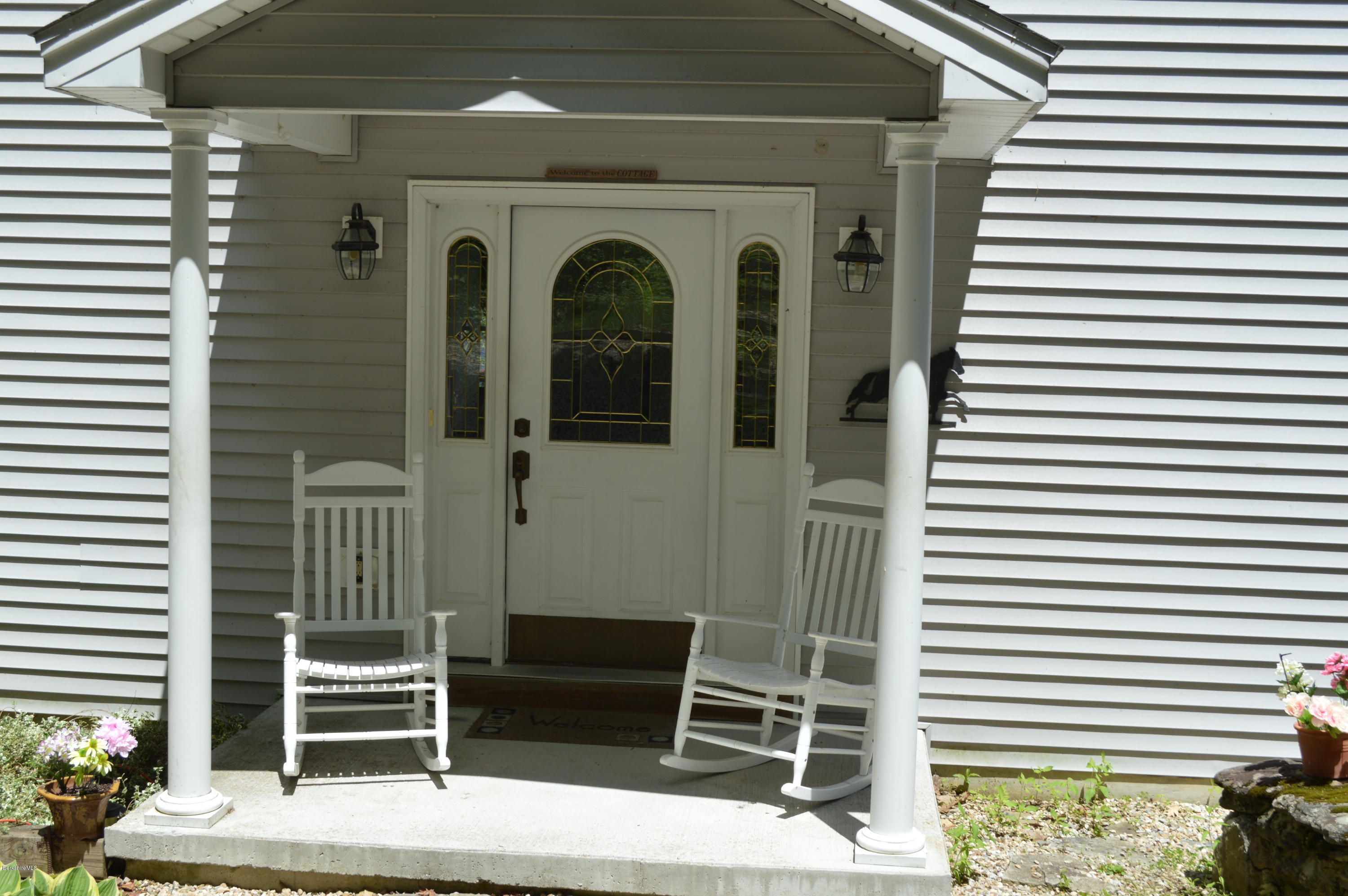 1381 East Otis Road Otis, MA 01029 - Photo 44 of 48 a front view of a house with a porch