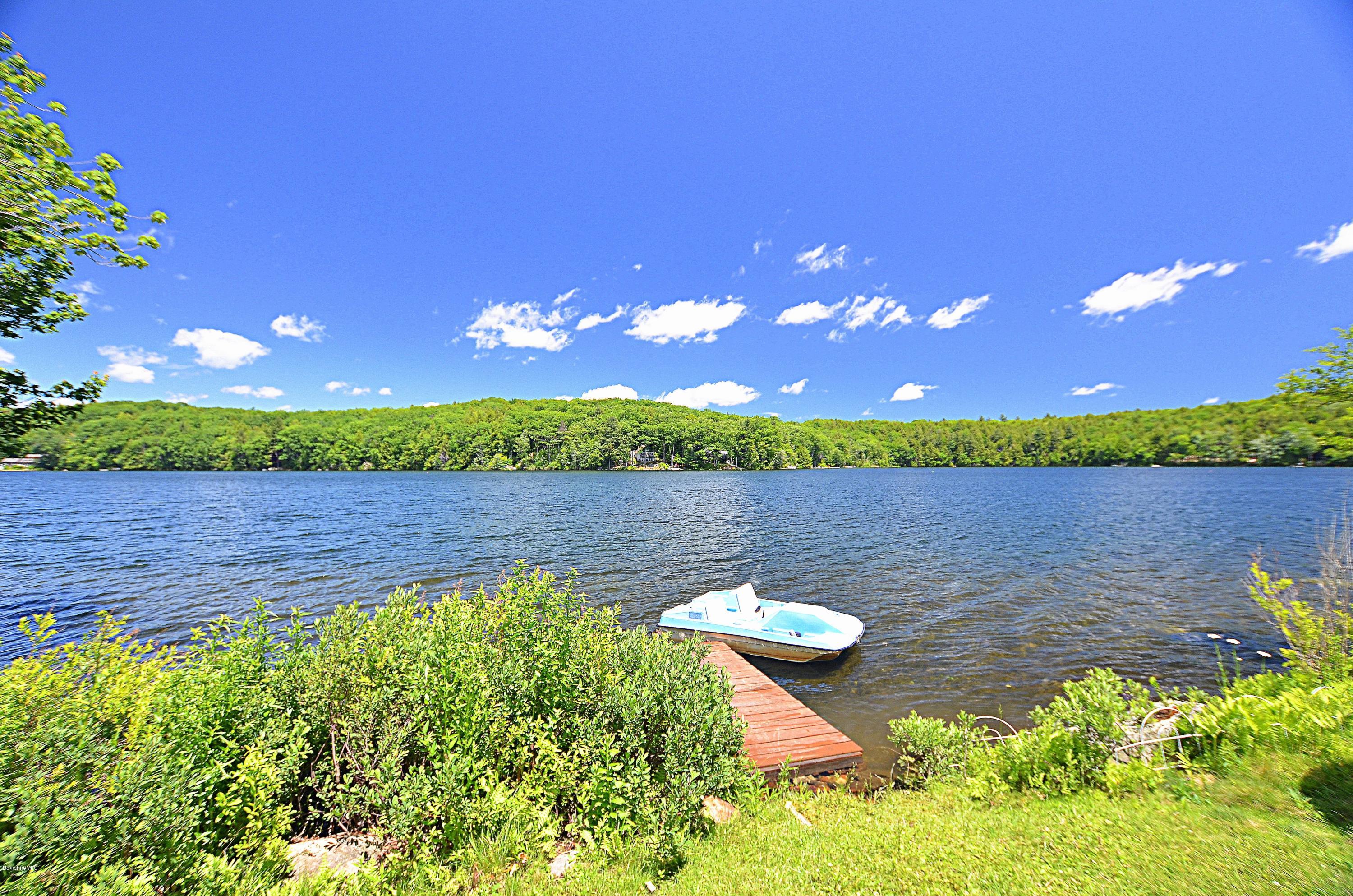1381 East Otis Road Otis, MA 01029 - Photo 47 of 48 a view of a lake with a house in the background