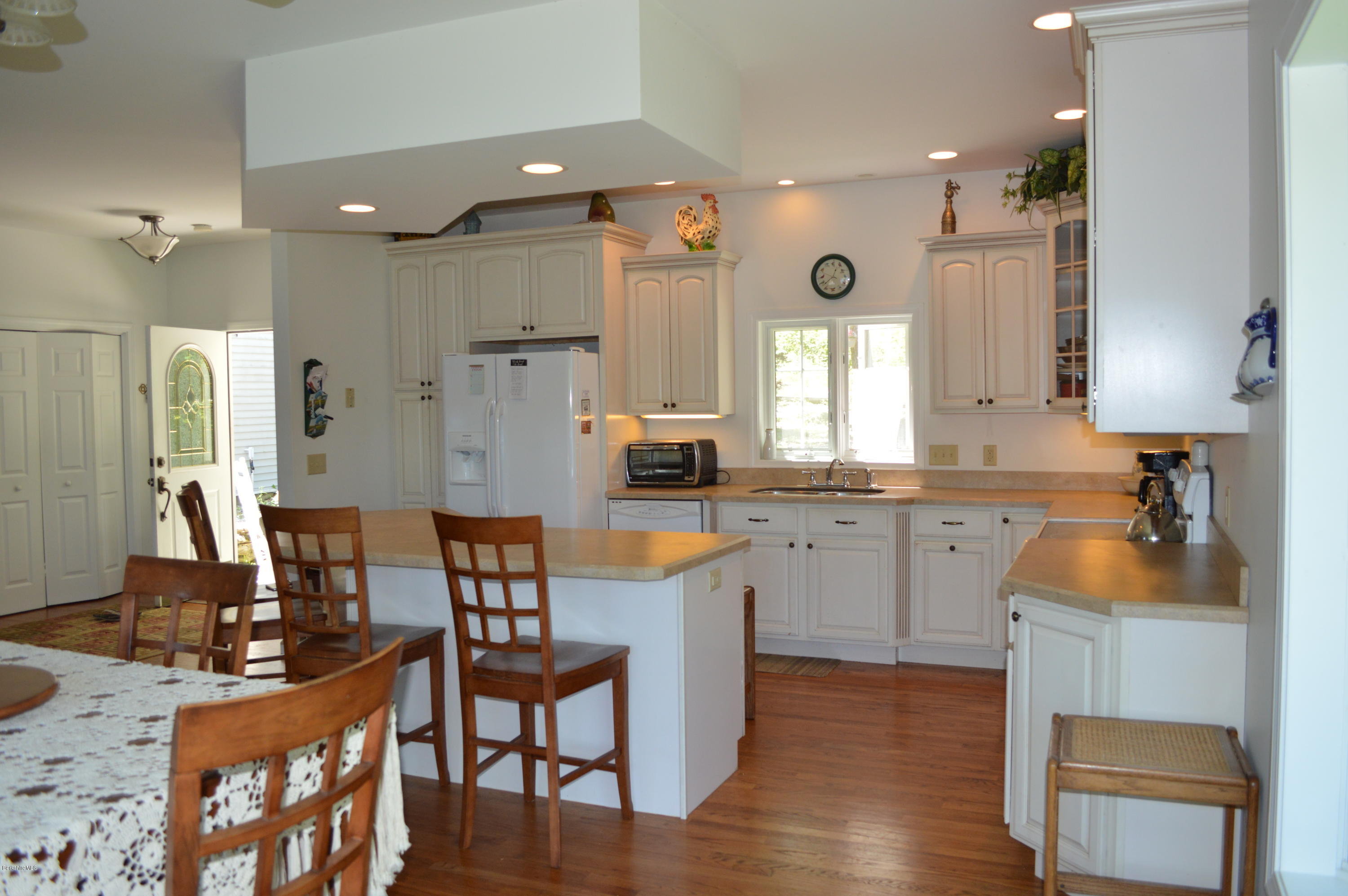 1381 East Otis Road Otis, MA 01029 - Photo 6 of 48 a kitchen with granite countertop a table chairs stove a sink and dishwasher