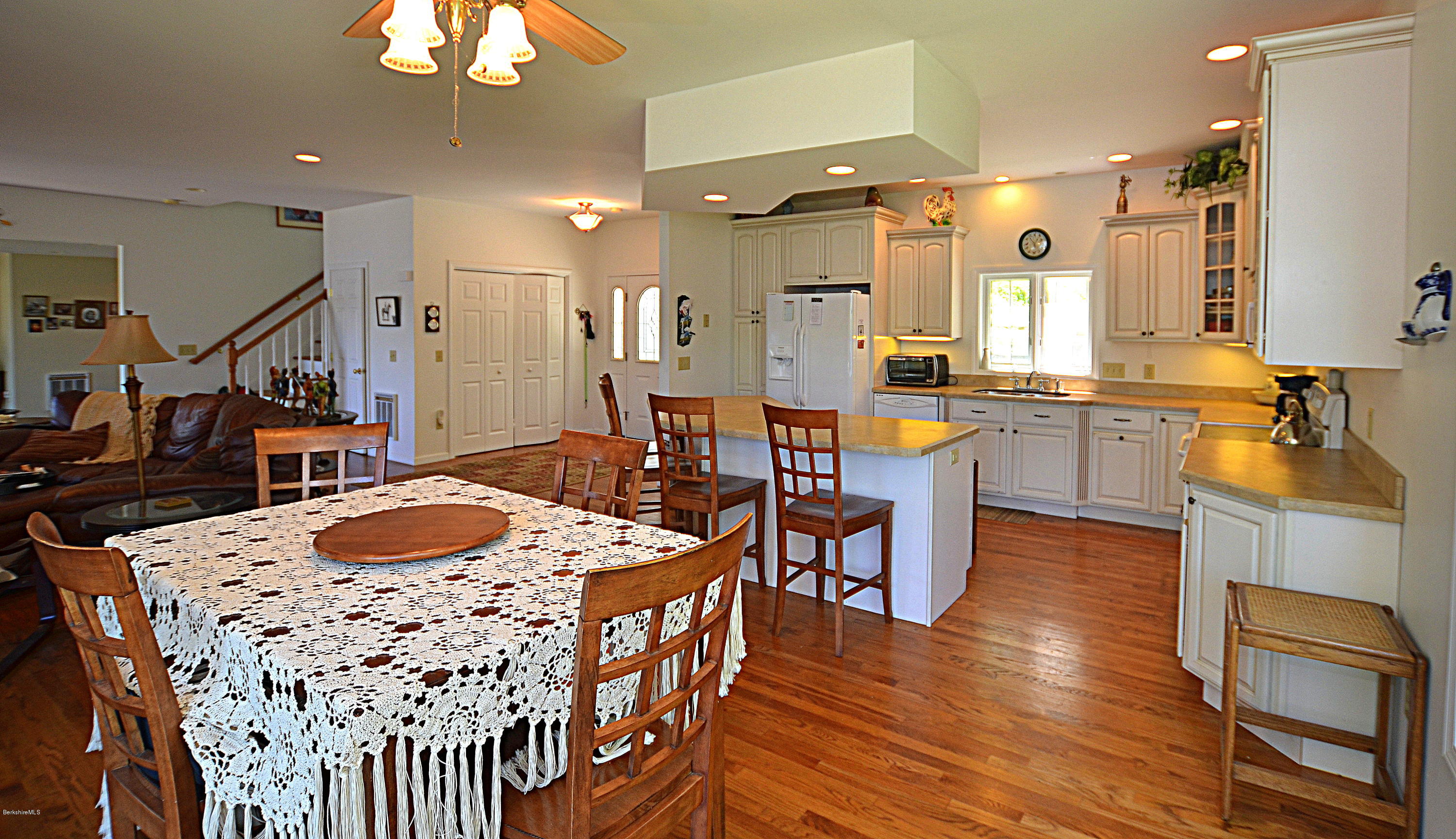 1381 East Otis Road Otis, MA 01029 - Photo 8 of 48 a kitchen with stainless steel appliances kitchen island granite countertop wooden floor dining table and chairs