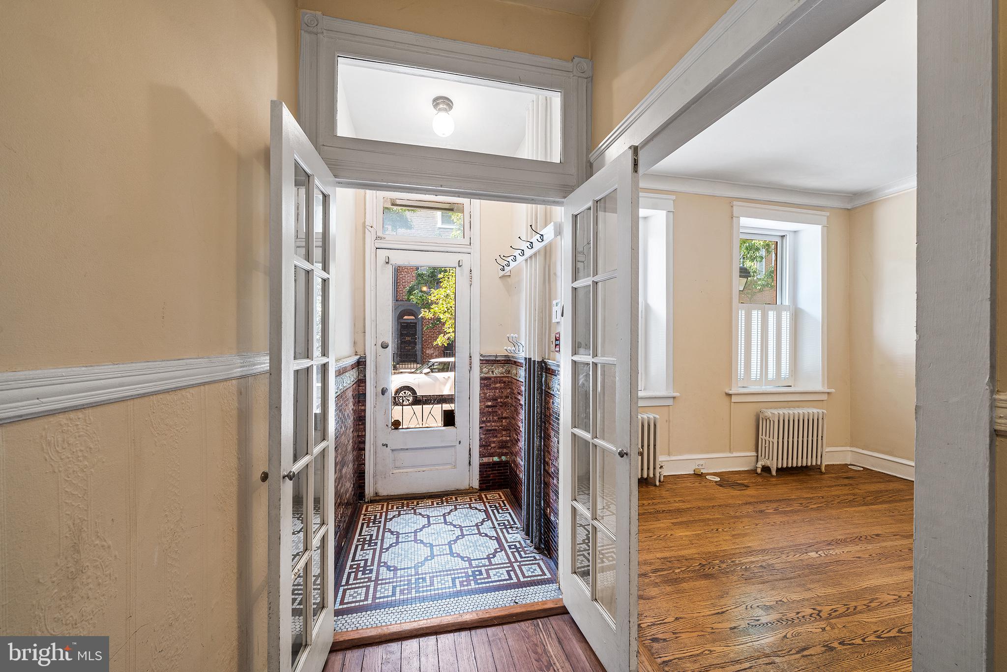 231 Pine Street, Unit 1 Philadelphia, PA 19106 - Photo 5 of 14 a view of a livingroom with wooden floor and a refrigerator