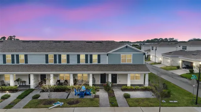 a front view of a residential apartment building with a yard