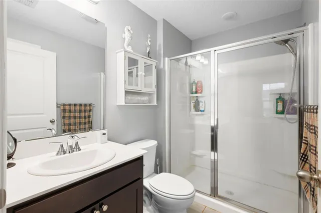 a bathroom with a sink toilet a mirror and shower