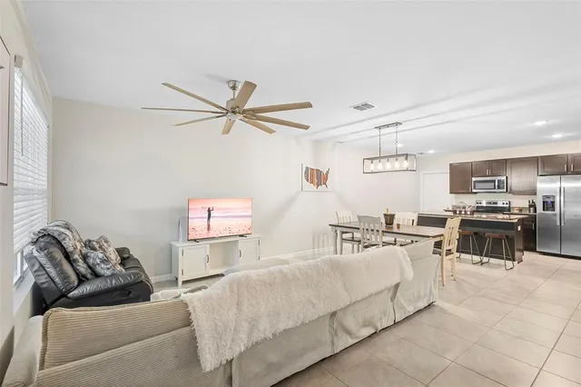 a living room with furniture and kitchen view
