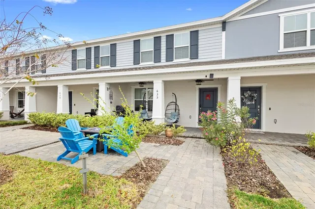 a front view of a house with outdoor seating