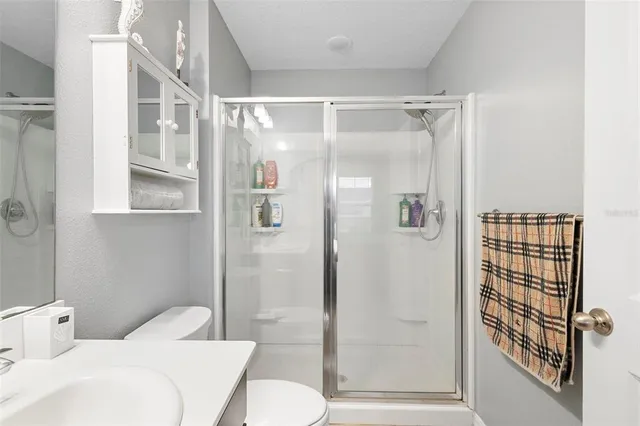 a bathroom with a shower toilet and sink