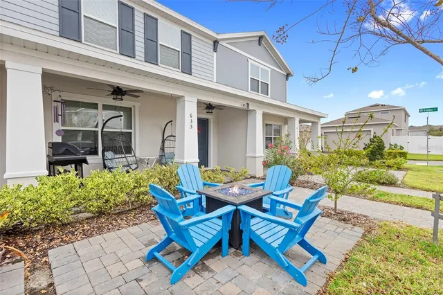 a view of a house with backyard and sitting area