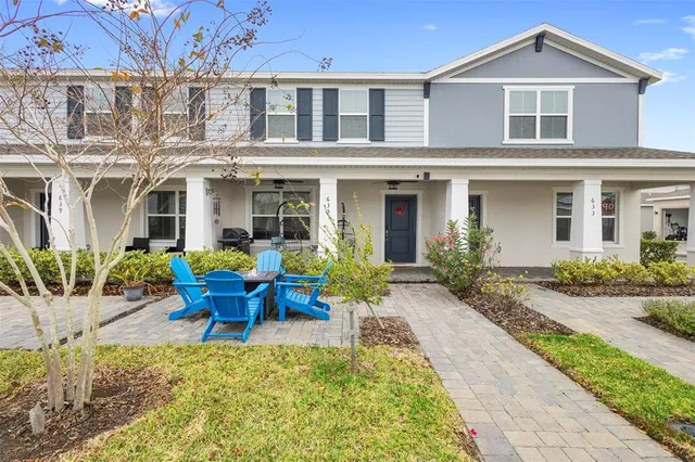 a view of a house with backyard sitting area and garden
