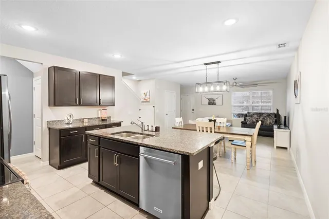a kitchen with stainless steel appliances granite countertop a sink and stove