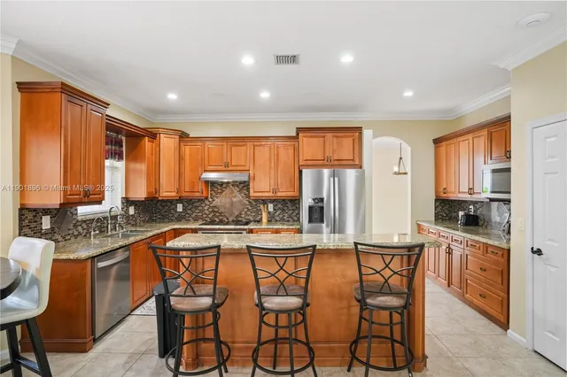 a kitchen with stainless steel appliances granite countertop counter space a sink and cabinets