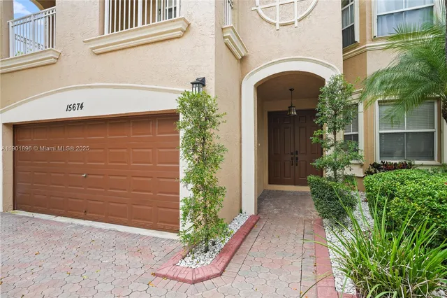 a view of a house with potted plants