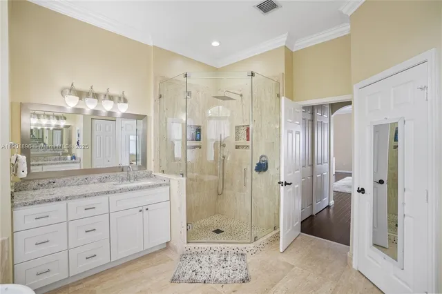 a bathroom with a granite countertop sink mirror and shower