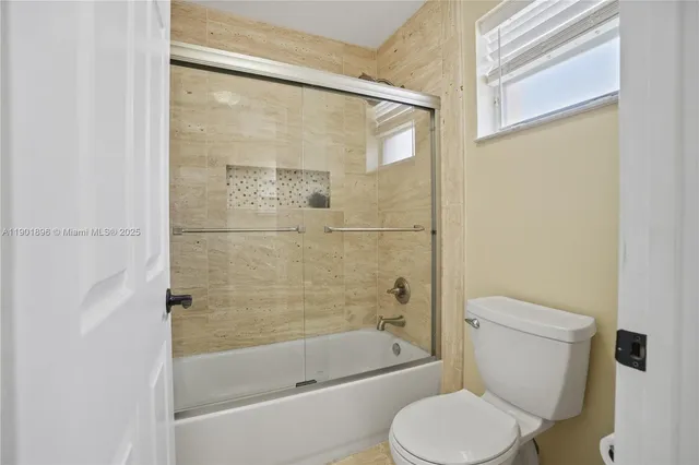 a bathroom with a toilet and a bathtub