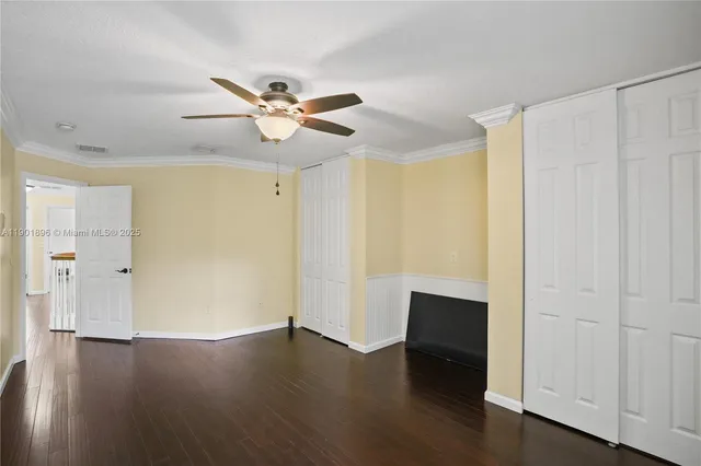 a view of room with wooden floor and fan