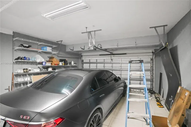 a view of garage with cars