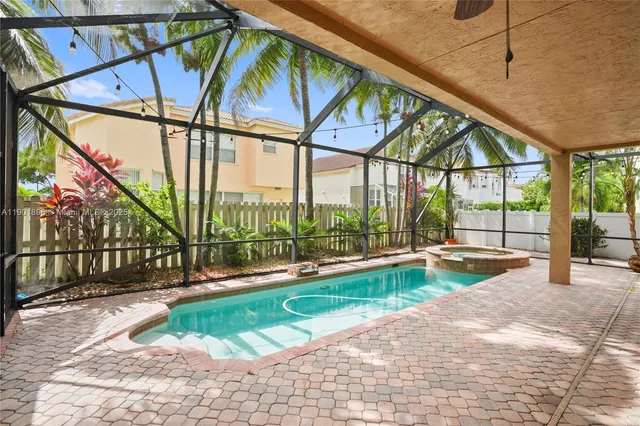 a view of a swimming pool with a couches in a patio