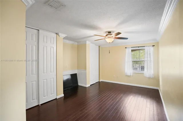 a view of staircase with railing and white walls