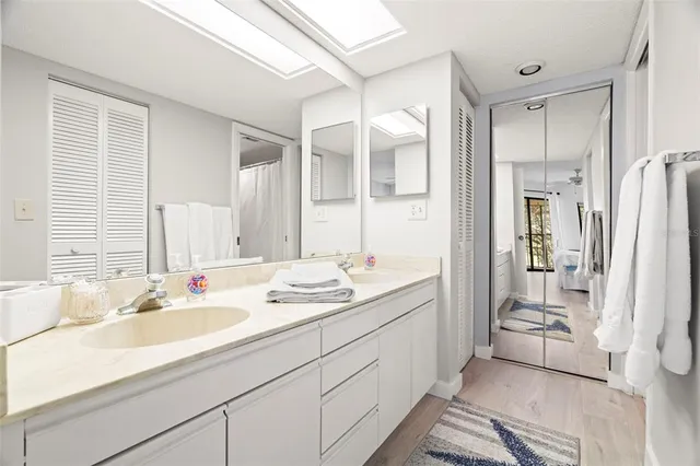 a spacious bathroom with a double vanity sink mirror and double