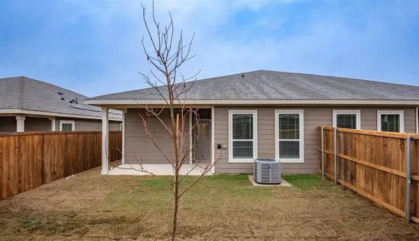 a backyard of a house with barbeque oven table and chairs