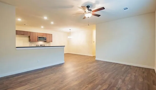 a kitchen with stainless steel appliances a refrigerator and a chandelier