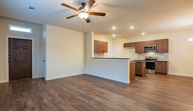 a view of a kitchen with a sink and a refrigerator