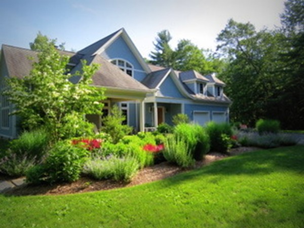 a front view of a house with a garden