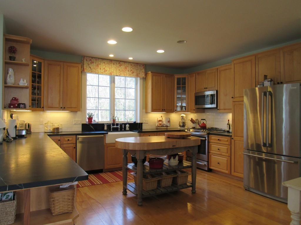 124 Turkey Hill Road Northampton, MA 01062 - Photo 11 of 30 a kitchen with a table chairs refrigerator and microwave