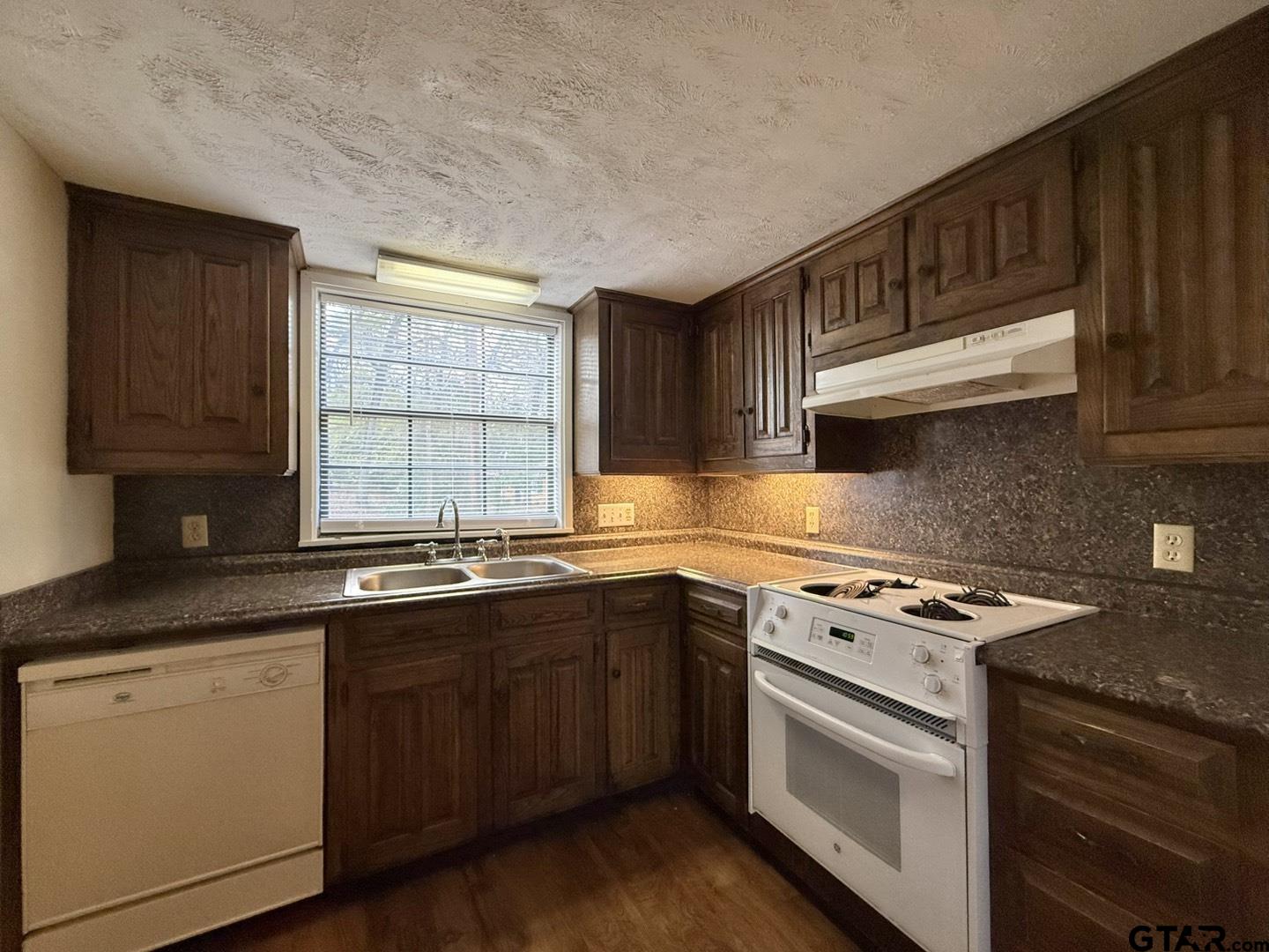 2510 Delmar Street Tyler, TX 75701 - Photo 3 of 18 a kitchen with stainless steel appliances granite countertop a sink stove and cabinets