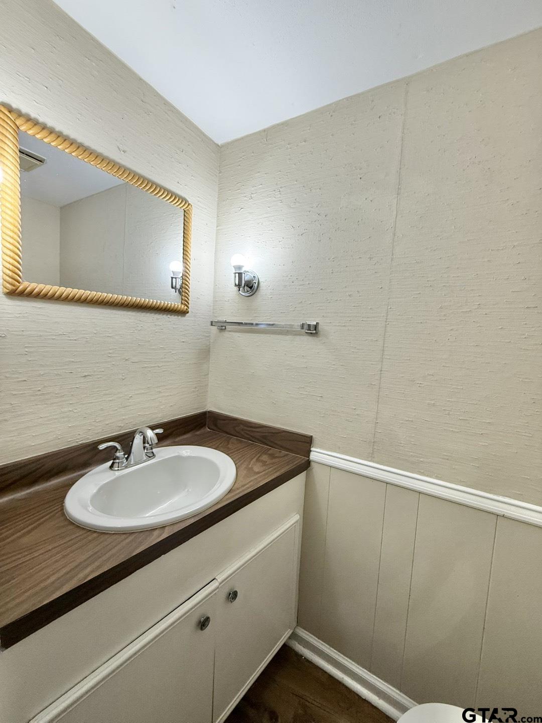 2510 Delmar Street Tyler, TX 75701 - Photo 5 of 18 a bathroom with a sink and a mirror
