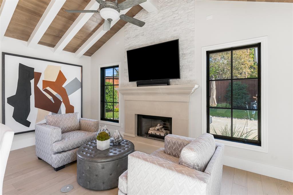 3922 Inwood Road Dallas, TX 75209 - Photo 12 of 35 a living room with furniture a flat screen tv and a fireplace