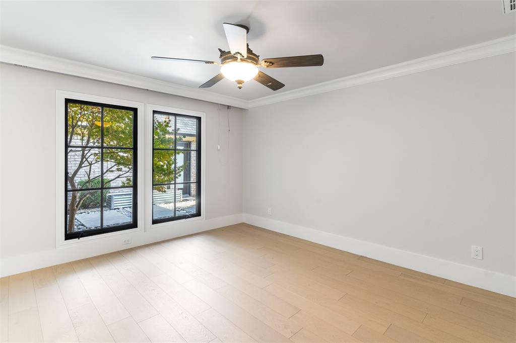 3922 Inwood Road Dallas, TX 75209 - Photo 19 of 35 an empty room with windows and ceiling fan