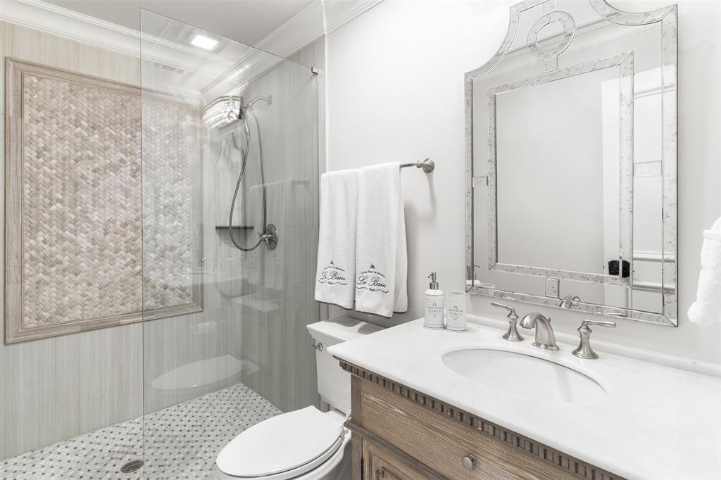 3922 Inwood Road Dallas, TX 75209 - Photo 20 of 35 a bathroom with a sink toilet double vanity and shower